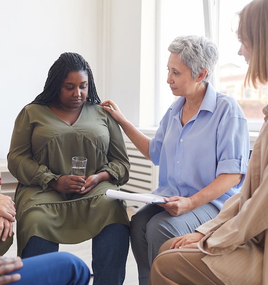 Support group comforting a participant during residential trauma-informed care
