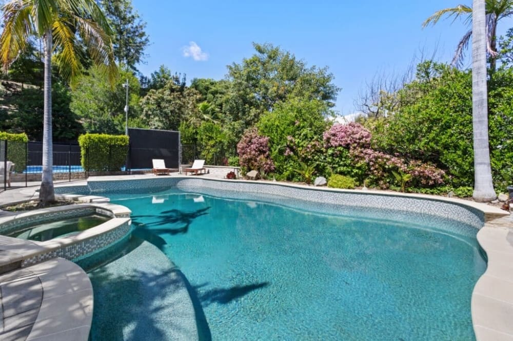 Outdoor swimming pool and spa at a Victory Bay residential treatment center in California