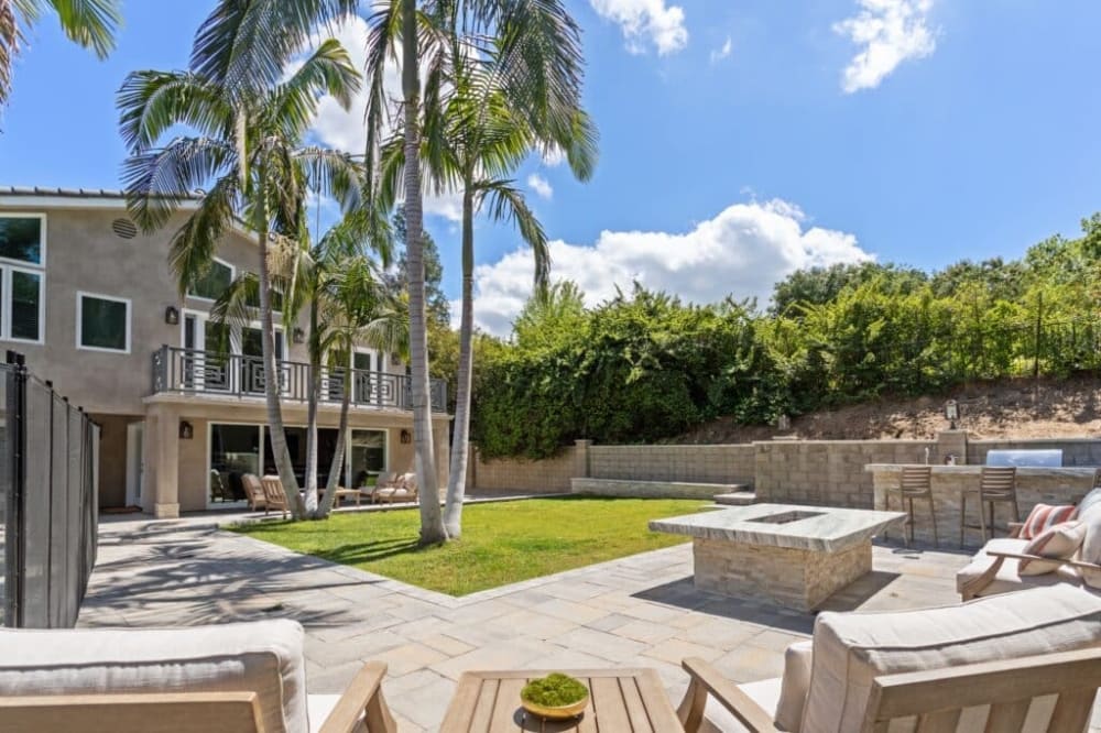 Landscaped backyard patio with fire-pit lounge at a Victory Bay residential mental health facility in California