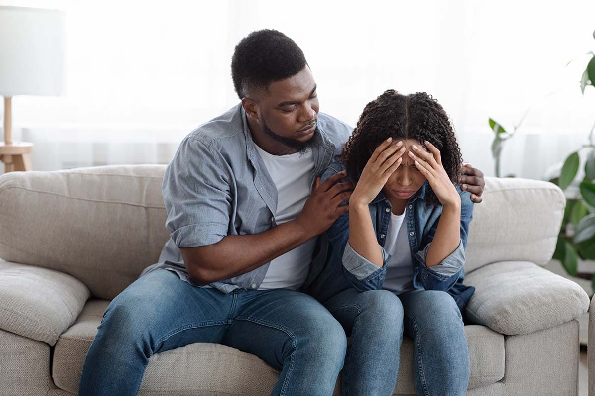 Partner comforting a distressed adult during relationship turmoil
